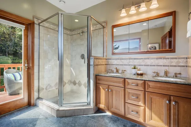 a bathroom with a granite countertop sink a toilet and a shower
