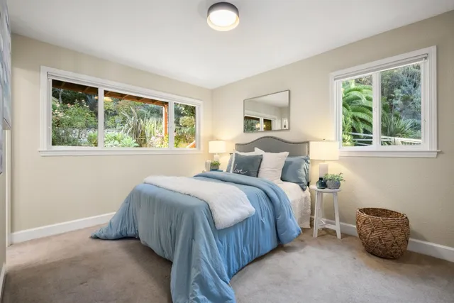 a bedroom with furniture and a window