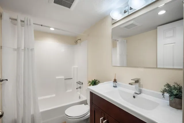 a view of a dry yard with wooden fence