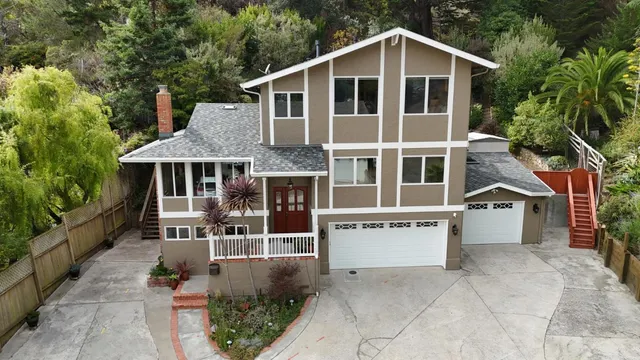 a living room with furniture a fireplace and a table