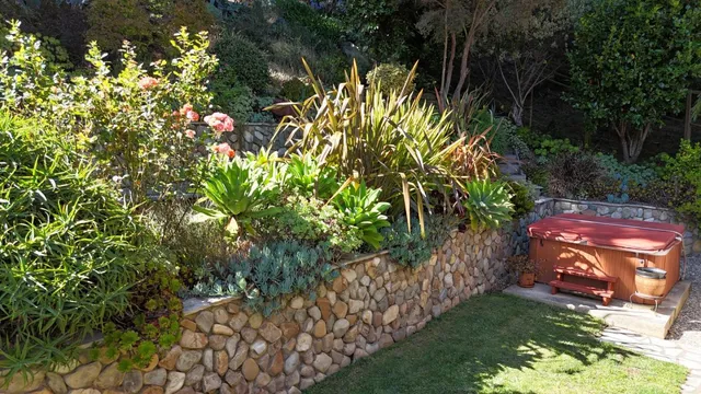 a view of a yard with wooden stairs and bench