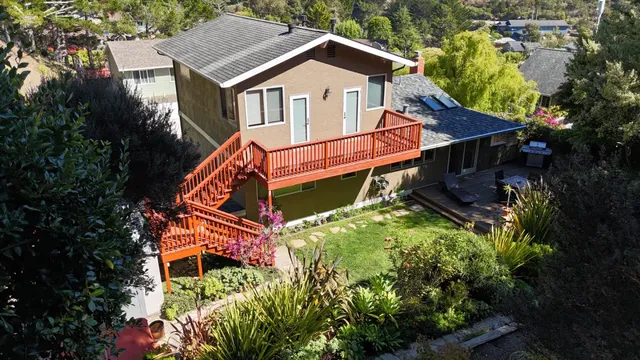 a view of a lush green hillside and a houses