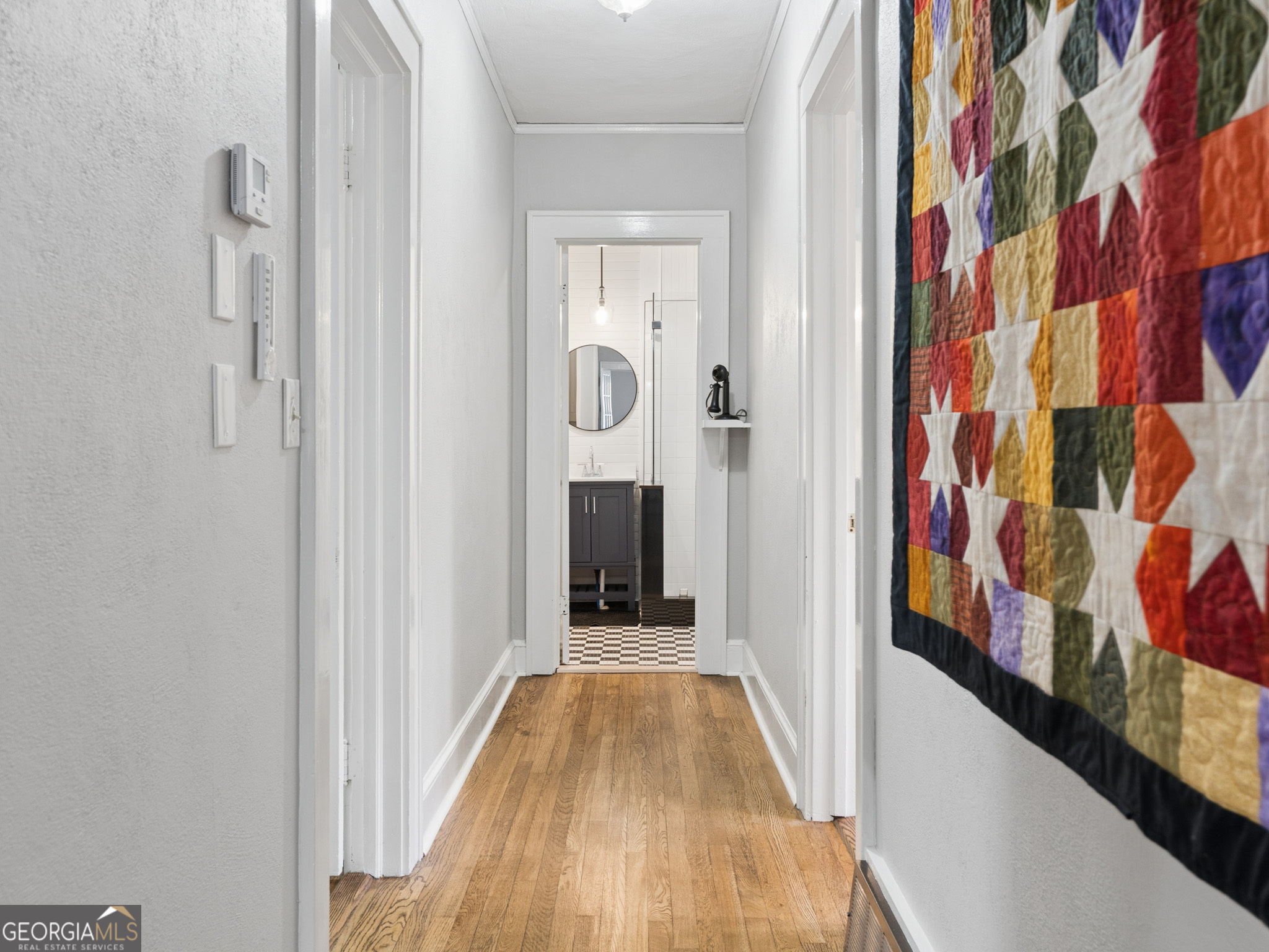 183 Athens Street Hartwell, GA 30643 - Photo 13 of 19 a view of a hallway with wooden floor and dining room