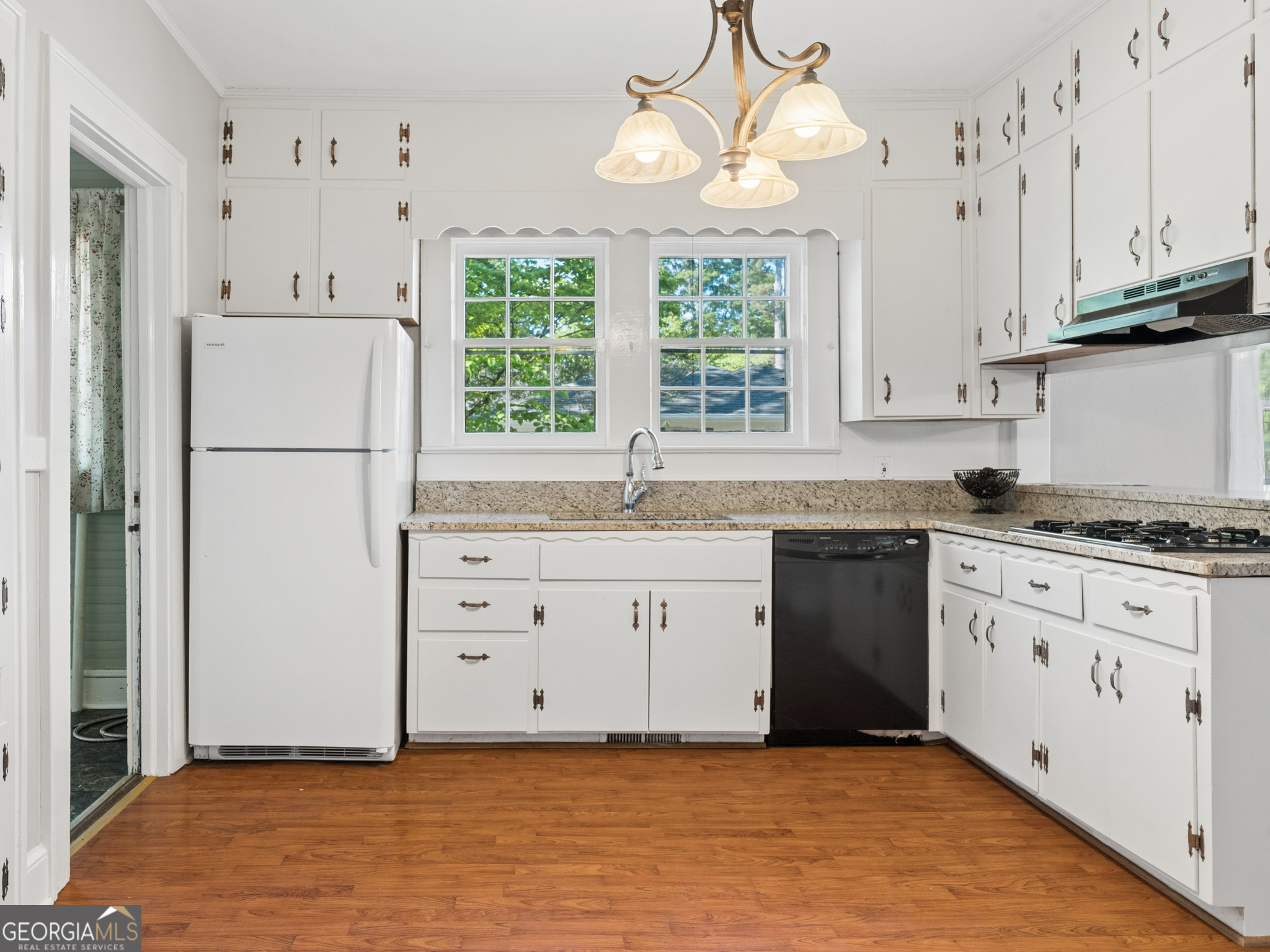 183 Athens Street Hartwell, GA 30643 - Photo 7 of 19 a kitchen with granite countertop white cabinets and white appliances