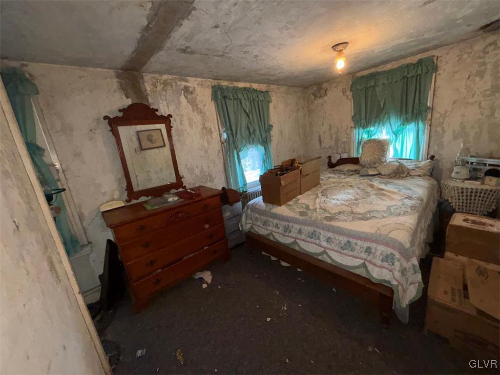 899 Browntown Road Nazareth, PA 18064 - Photo 5 of 10 a bedroom with a bed a mirror on dresser and a desk