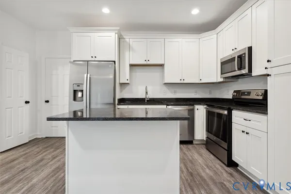 a kitchen with stainless steel appliances white cabinets and a granite counter tops