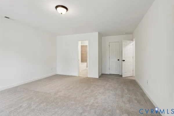 an empty room with closet area and mirrors
