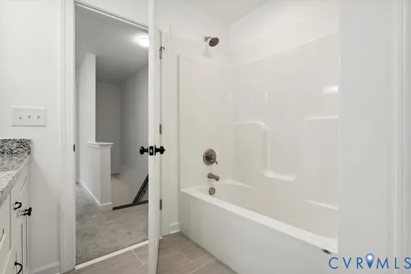 a bathroom with a bathtub and shower