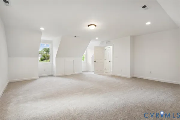 an empty room with windows and closet