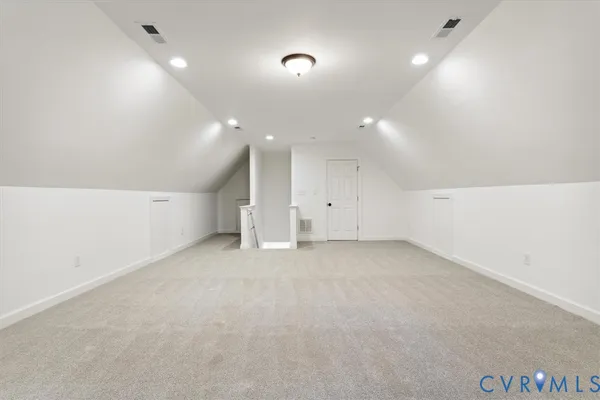 an empty room with an entryway and fan