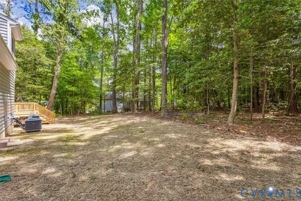 a view of a field with trees in the background