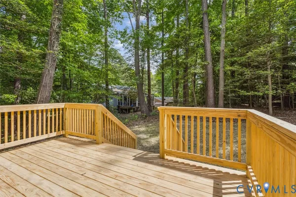 a view of balcony with wooden floor and fence