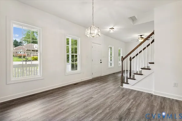 a view of an entryway with wooden floor and windows