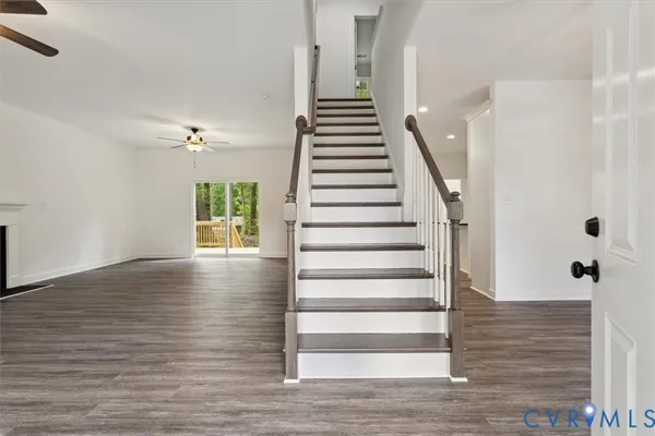 a view of entryway and hall with wooden floor