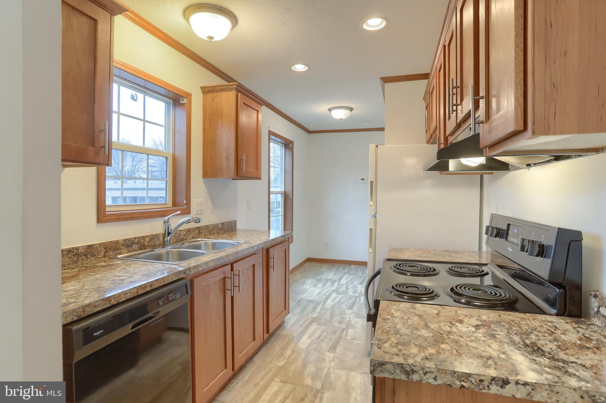 14 Shellie Street Lebanon, PA 17046 - Photo 7 of 19 a kitchen with stainless steel appliances granite countertop a sink a stove and a microwave
