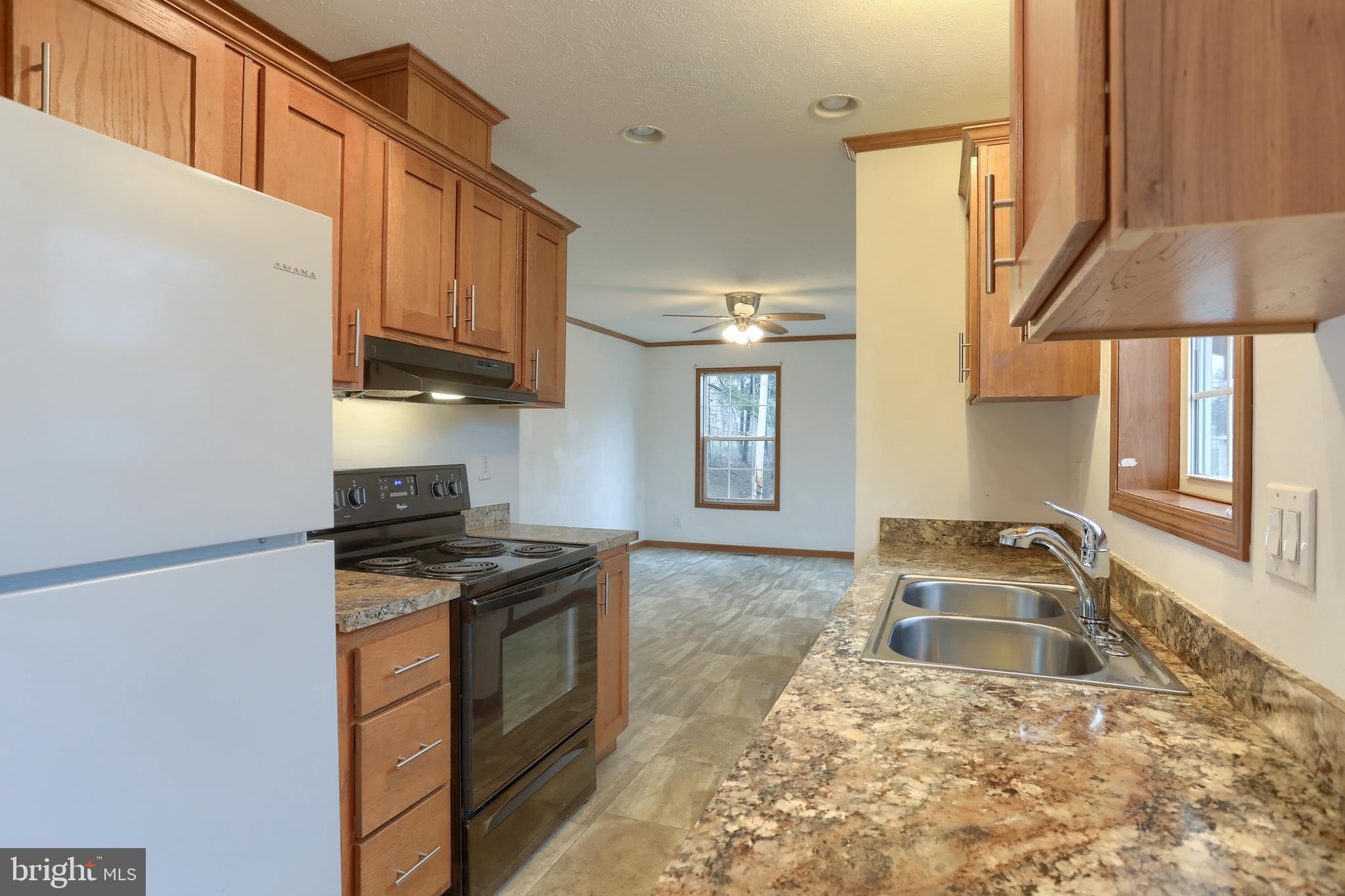 14 Shellie Street Lebanon, PA 17046 - Photo 9 of 19 a kitchen with granite countertop a stove a sink and a refrigerator