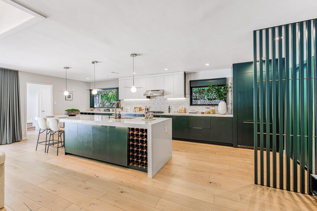 1349 Murchison Drive Millbrae, CA 94030 - Photo 20 of 66 a kitchen with kitchen island a counter top space a sink stainless steel appliances and cabinets
