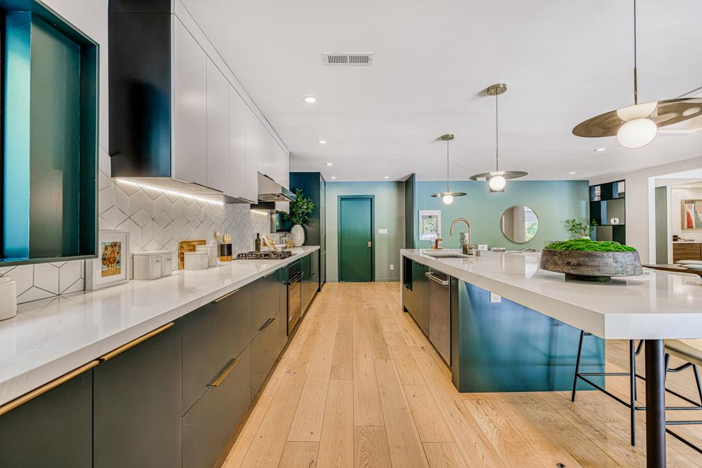 1349 Murchison Drive Millbrae, CA 94030 - Photo 23 of 66 a large kitchen with a large counter top appliances and cabinets