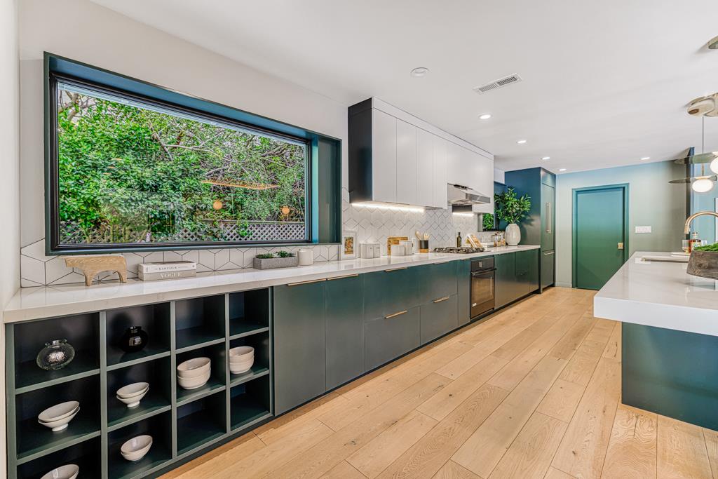 1349 Murchison Drive Millbrae, CA 94030 - Photo 24 of 66 a kitchen with stainless steel appliances kitchen island sink stove and cabinets