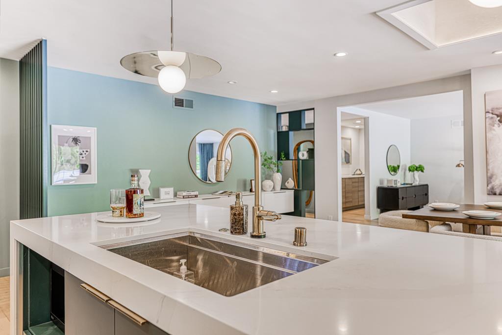1349 Murchison Drive Millbrae, CA 94030 - Photo 27 of 66 a kitchen with a sink a chandelier and living room view