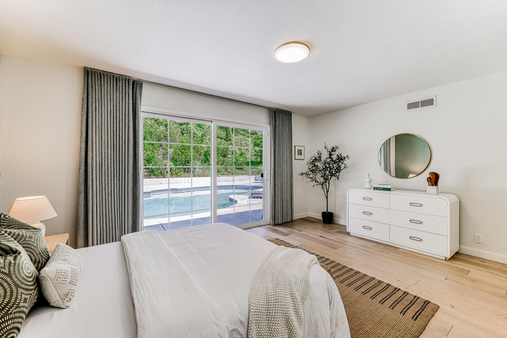 1349 Murchison Drive Millbrae, CA 94030 - Photo 50 of 66 a bedroom with a bed potted plant a dresser and a window