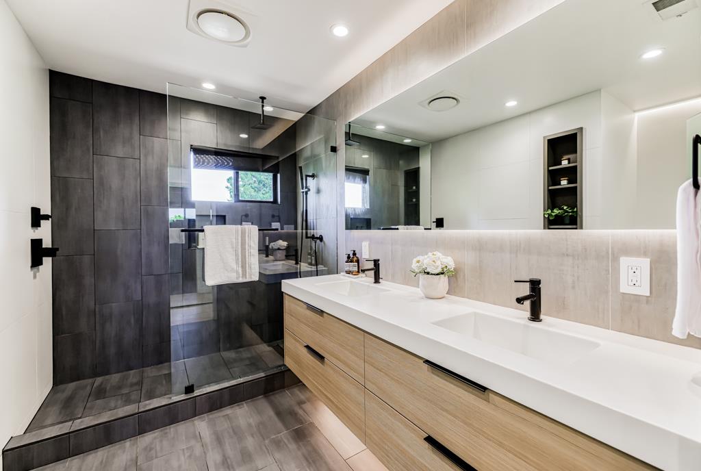 1349 Murchison Drive Millbrae, CA 94030 - Photo 51 of 66 a bathroom with a double vanity sink a mirror and shower