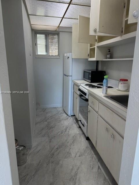 8601 Southwest 68th Court, Unit 23 Pinecrest, FL 33156 - Photo 3 of 9 a kitchen with cabinets and appliances