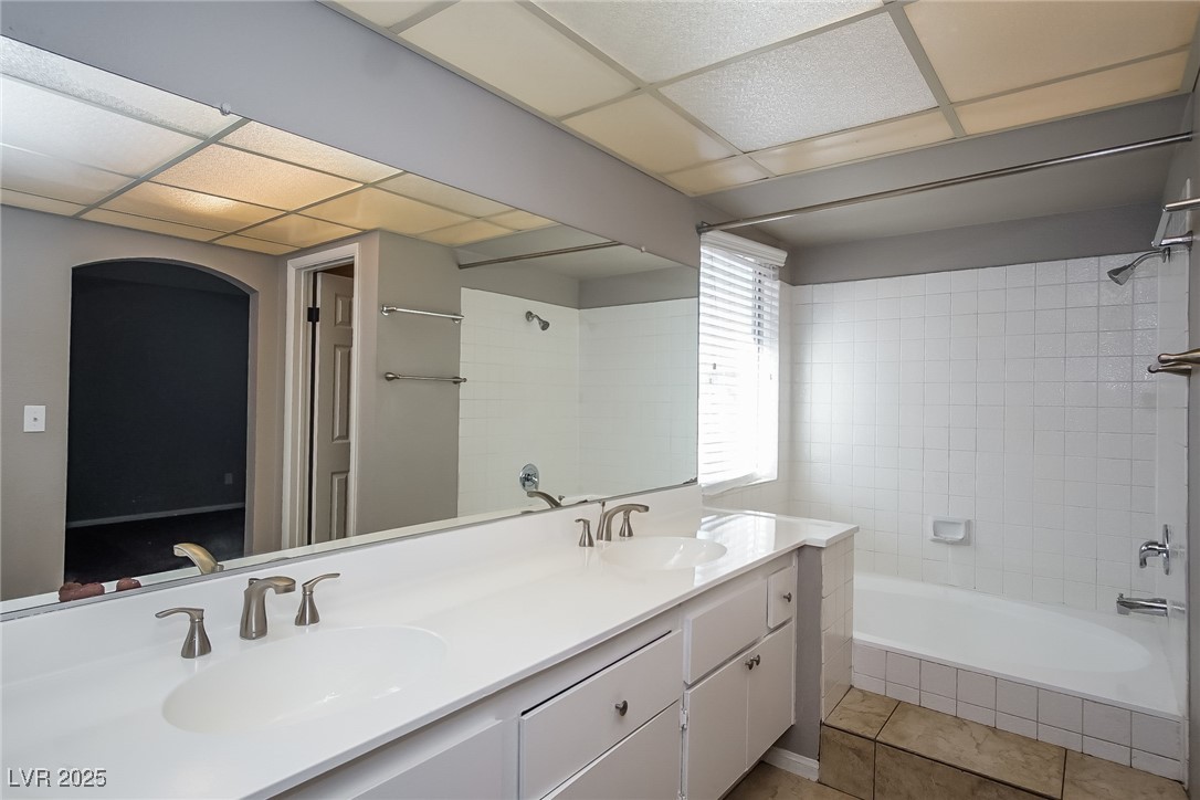 7118 Shadow Crest Drive Las Vegas, NV 89119 - Photo 13 of 15 Full bathroom featuring double vanity, tiled showe