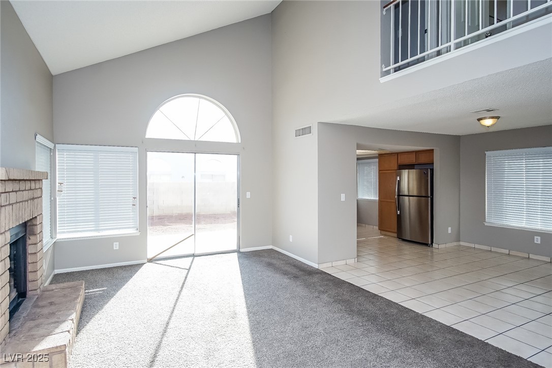 7118 Shadow Crest Drive Las Vegas, NV 89119 - Photo 2 of 15 Unfurnished living room with high vaulted ceiling,