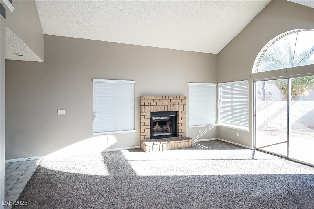 7118 Shadow Crest Drive Las Vegas, NV 89119 - Photo 3 of 15 Unfurnished living room with high vaulted ceiling,