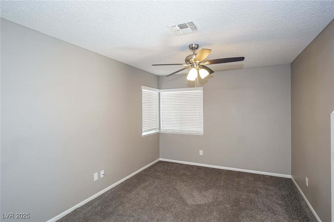7118 Shadow Crest Drive Las Vegas, NV 89119 - Photo 6 of 15 Spare room featuring carpet, baseboards, a texture