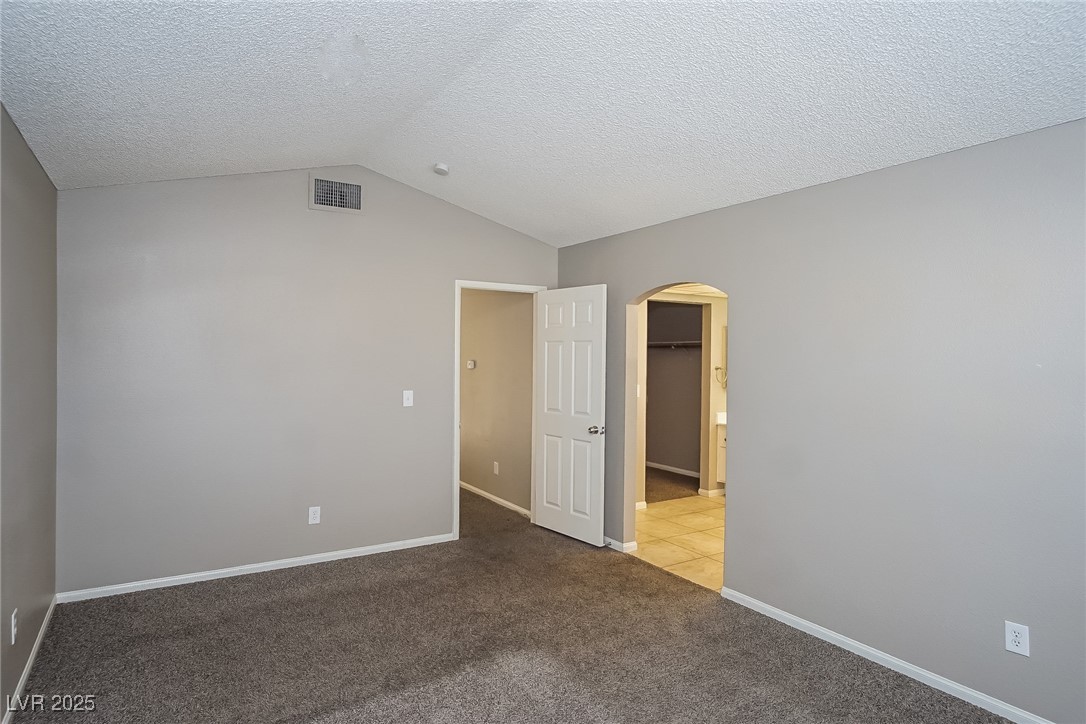 7118 Shadow Crest Drive Las Vegas, NV 89119 - Photo 9 of 15 Unfurnished bedroom with carpet flooring, a textur