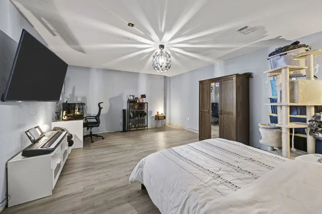 a bedroom with a bed and a flat screen tv