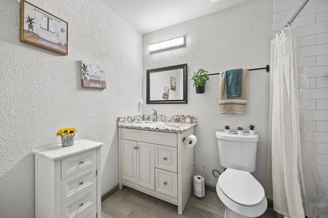a view of bathroom with a toilet sink and mirror