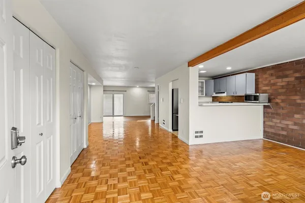 a view of a kitchen with a refrigerator and a stove top oven