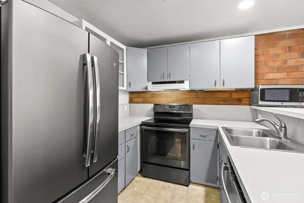 a kitchen with a sink stove and refrigerator