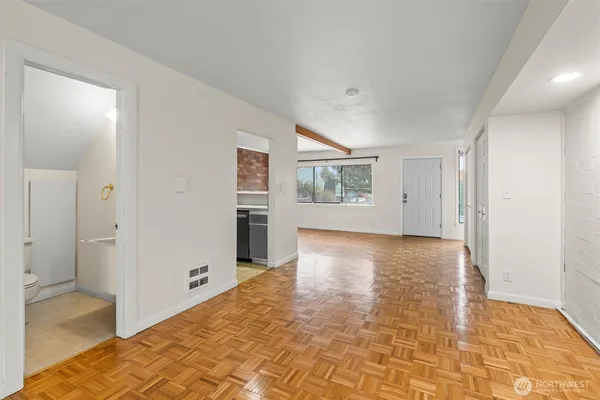 a view of a kitchen with wooden floor and a ceiling fan