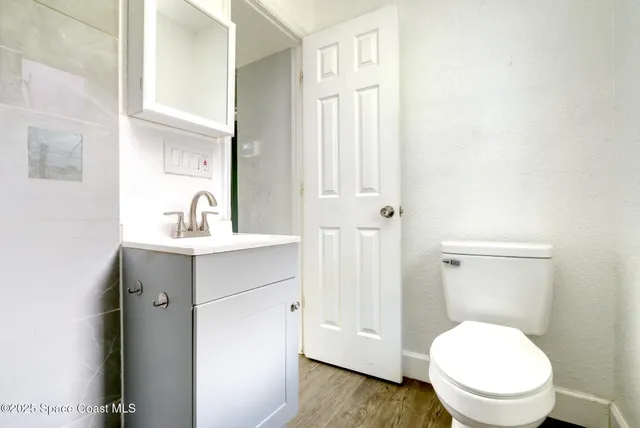a bathroom with a toilet a sink and a window