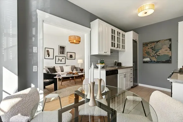a kitchen with stainless steel appliances kitchen island granite countertop a refrigerator and cabinets