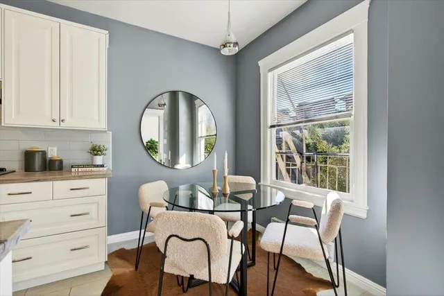 a dining room with furniture and a window