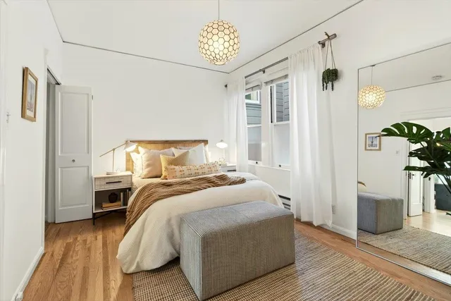 a bedroom with a bed and a chandelier