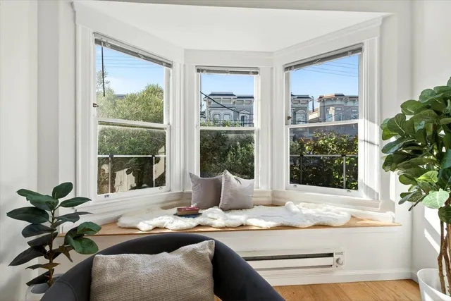 a living room with patio furniture and a potted plant