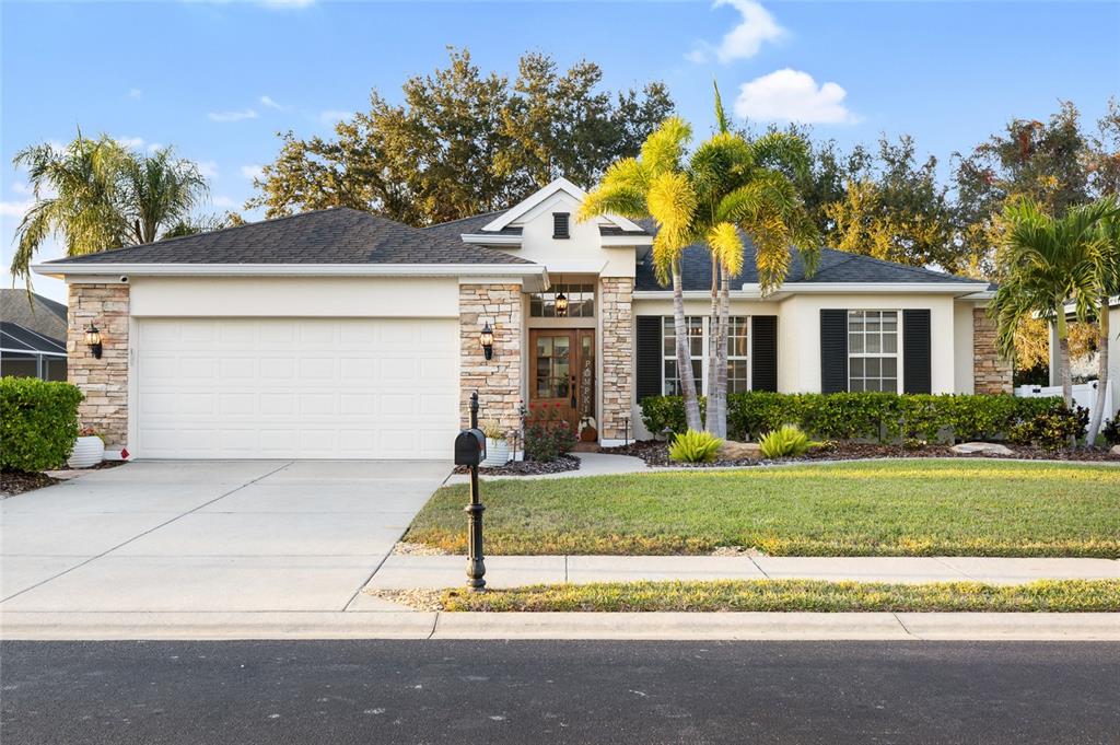 a front view of a house with a yard and garage