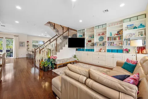 a living room with furniture and wooden floor