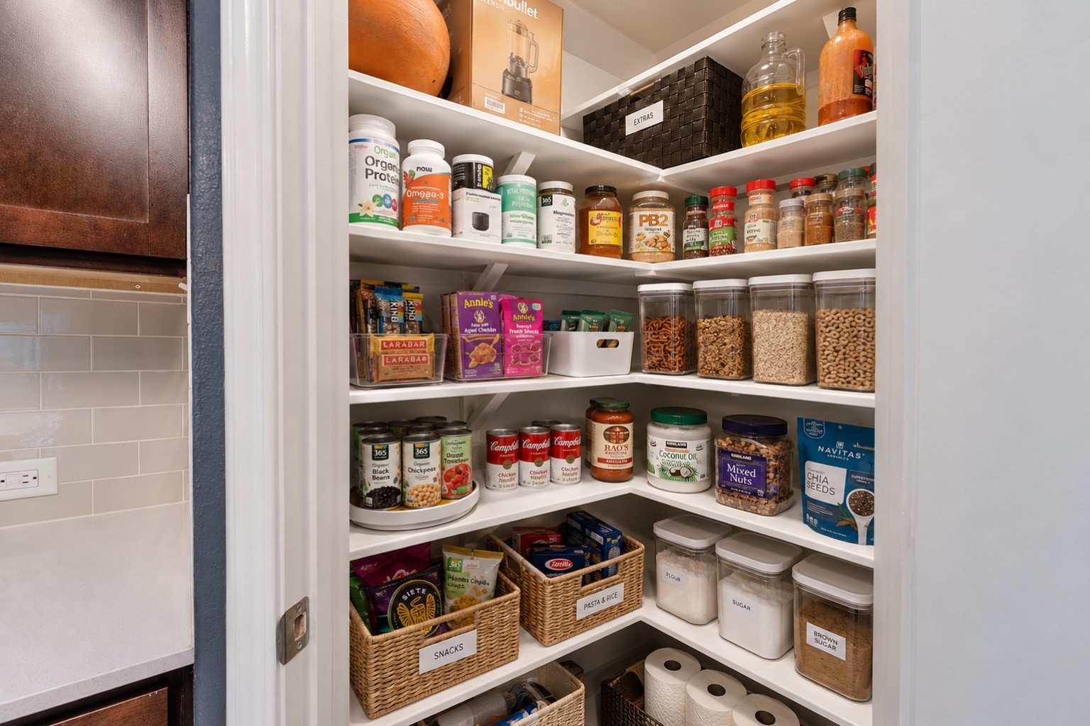 425 Perfect World Loop Jarrell, TX 76537 - Photo 9 of 28 A well-organized pantry offers abundant storage with white shelving and tidy containers.