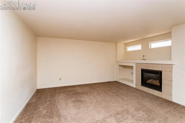 a view of empty room with a fireplace