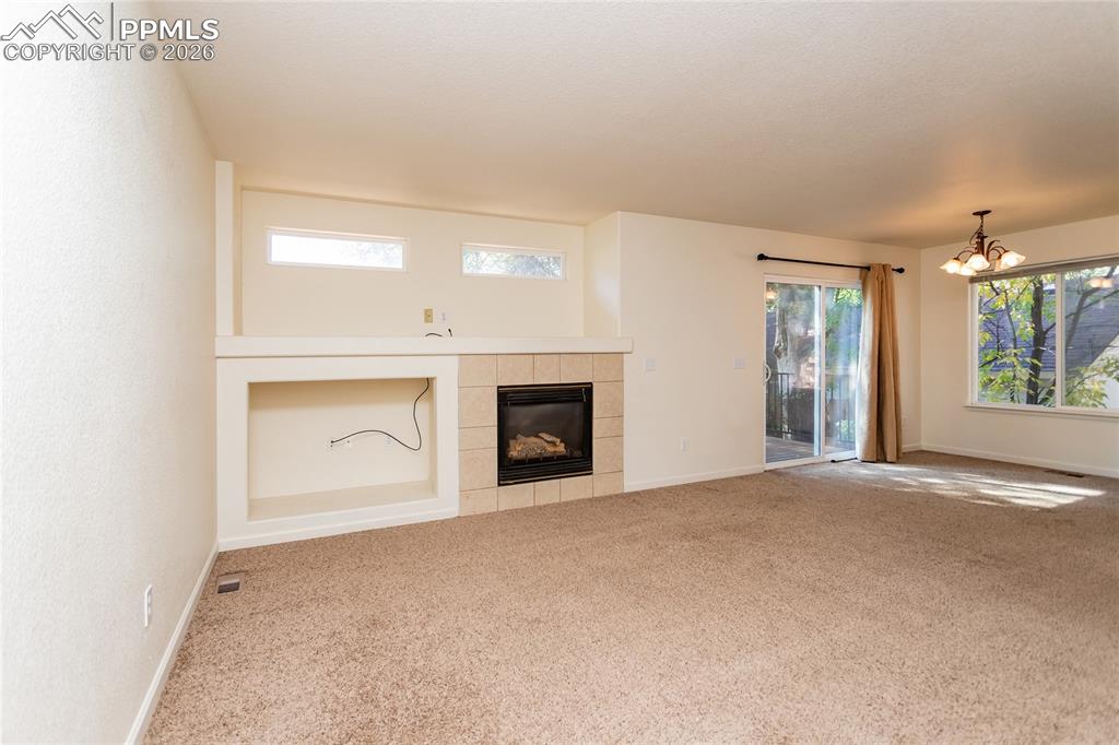414 West Cheyenne Road Colorado Springs, CO 80906 - Photo 12 of 45 an empty room with windows and fireplace