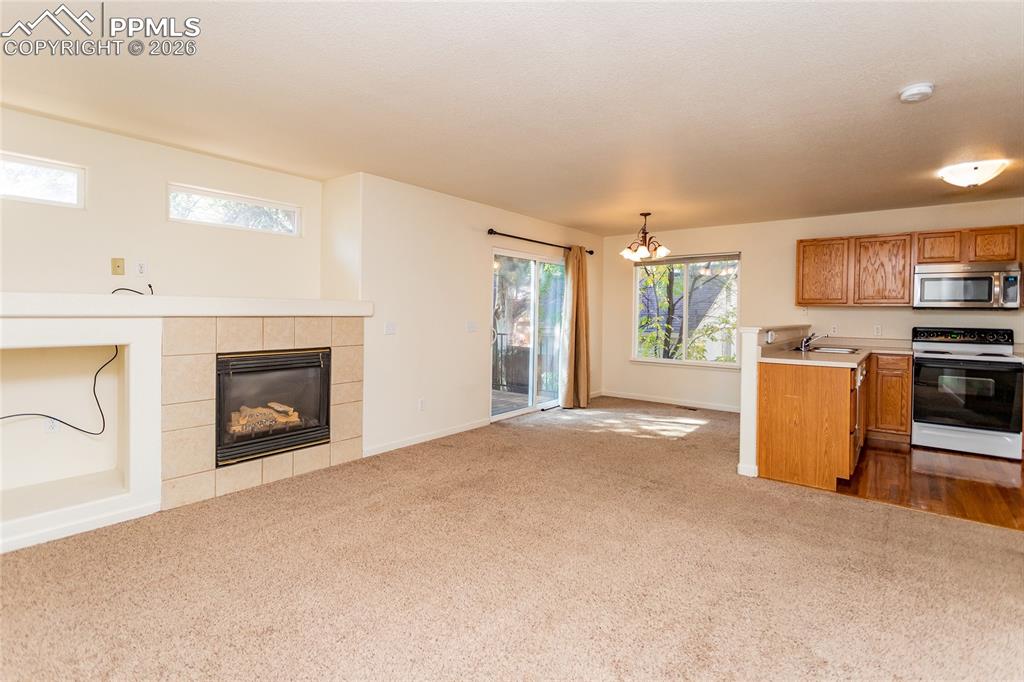 414 West Cheyenne Road Colorado Springs, CO 80906 - Photo 13 of 45 a view of a kitchen with a sink a microwave and a fireplace