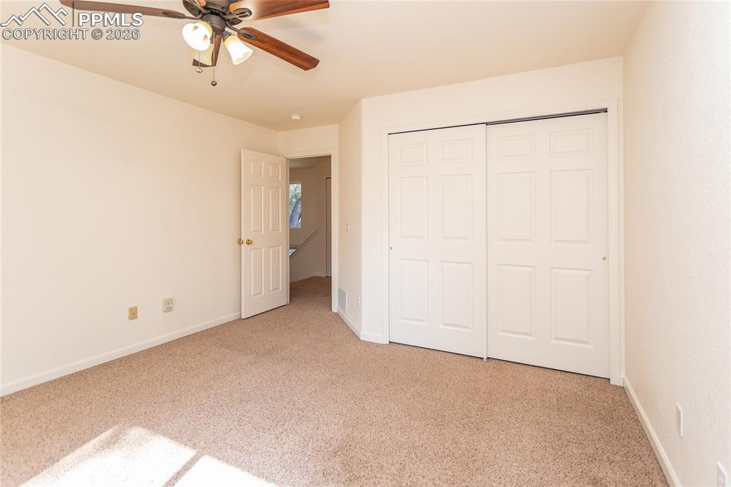 414 West Cheyenne Road Colorado Springs, CO 80906 - Photo 21 of 45 an empty room with a ceiling fan and a window