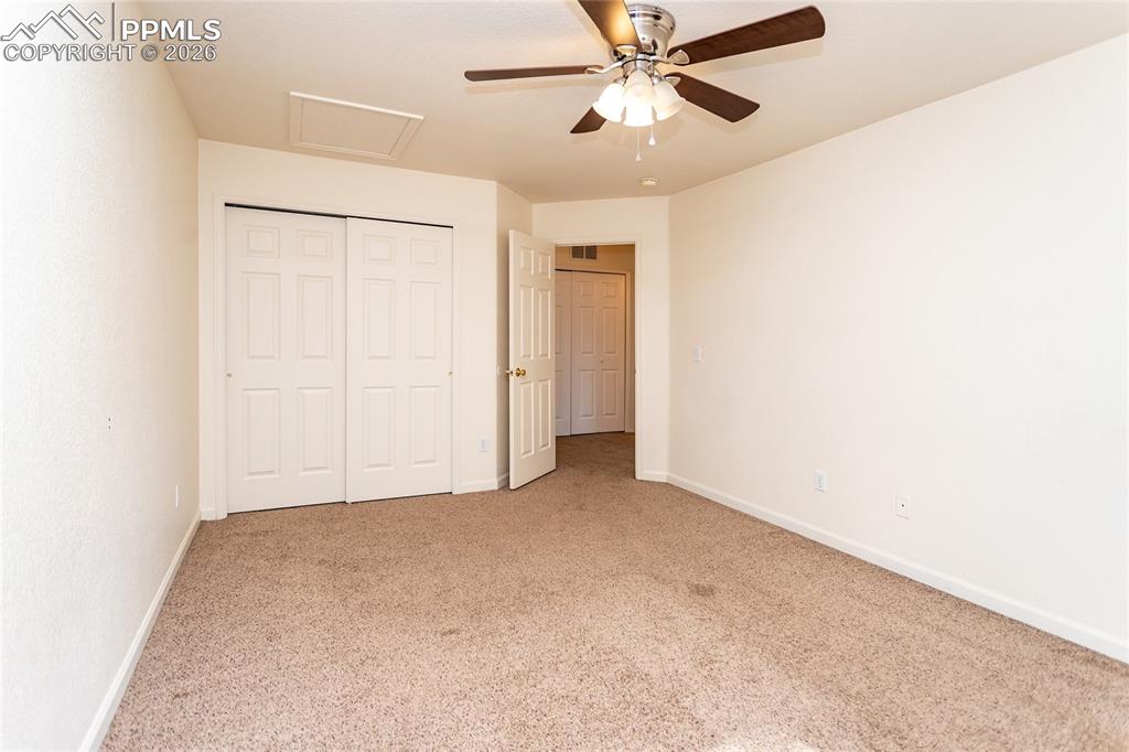414 West Cheyenne Road Colorado Springs, CO 80906 - Photo 26 of 45 an empty room with closet and a chandelier fan